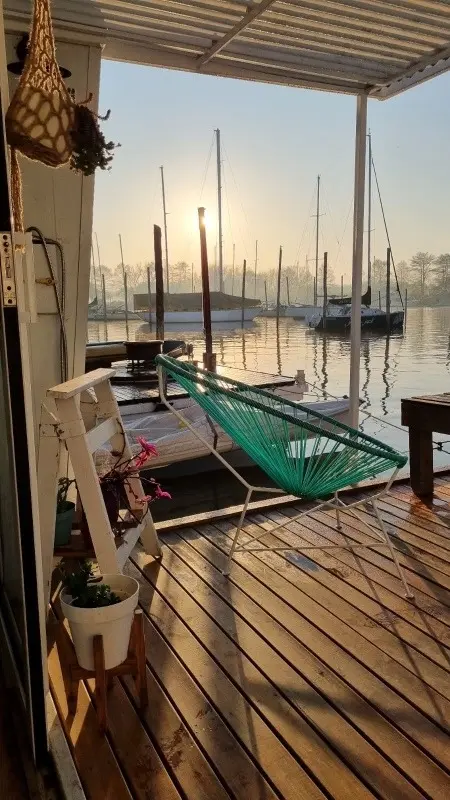 Floating house with deck and river views