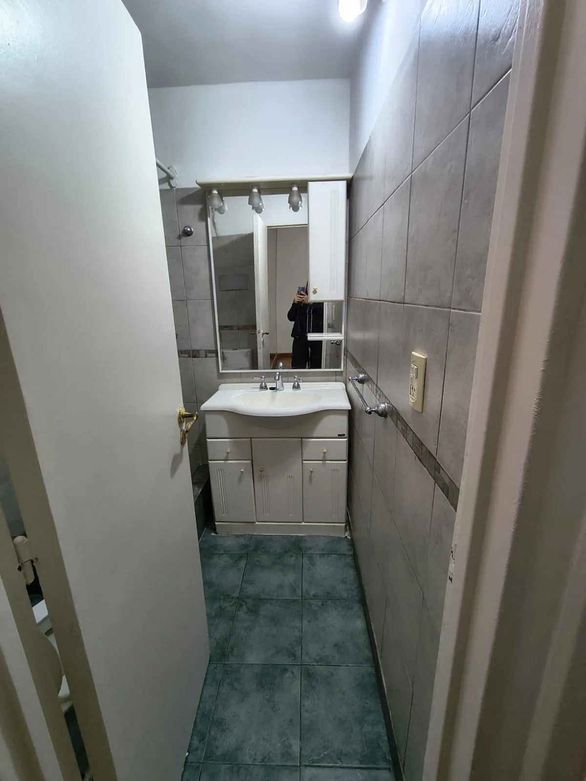 Bathroom with shower and tiles